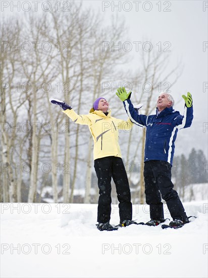 Caucasian couple enjoying snow