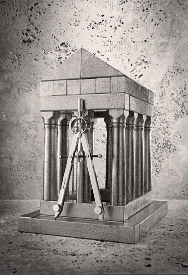Silver model of pillars and archway with compass