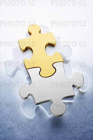 Close up of gold and silver puzzle pieces