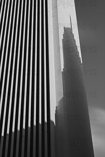 Skyscraper casting shadow on office building