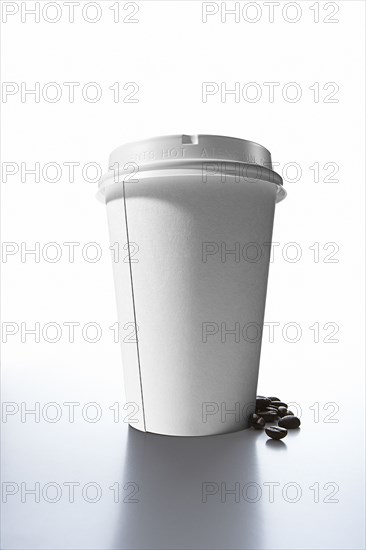 Coffee beans and paper cup