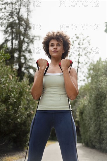 Mixed race woman exercising in park