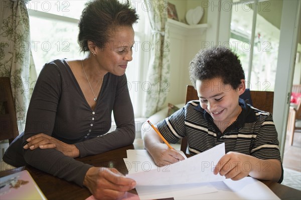 Grandmother helping grandson with homework