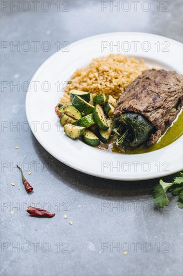 Plate of grilled pepper with vegetables and rice