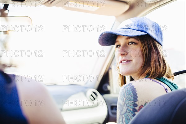 Caucasian couple driving in car on road trip