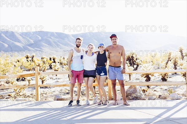 Caucasian friends smiling on desert path