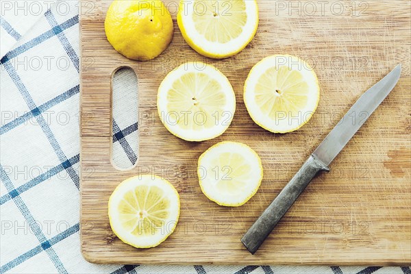 Sliced lemon on wooden cutting board