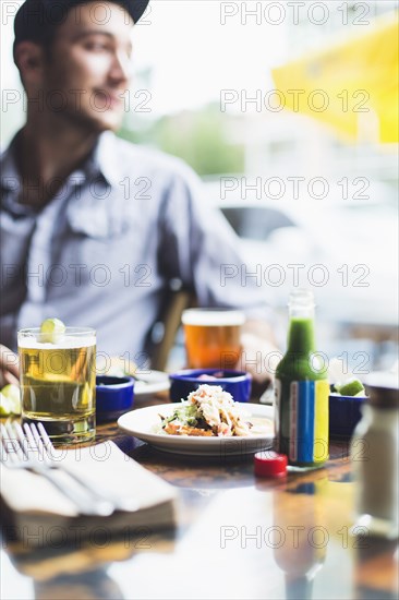 Caucasian man eating tacos in restaurant