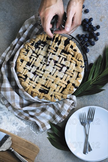 Caucasian man slicing blueberry pie