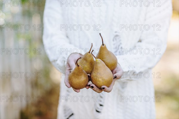 Caucasian woman holding pears