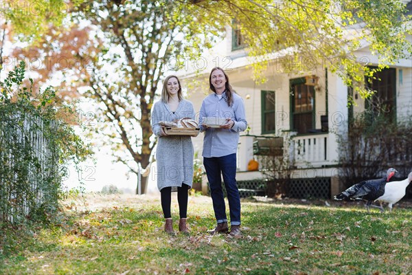 Caucasian couple smiling in backyard