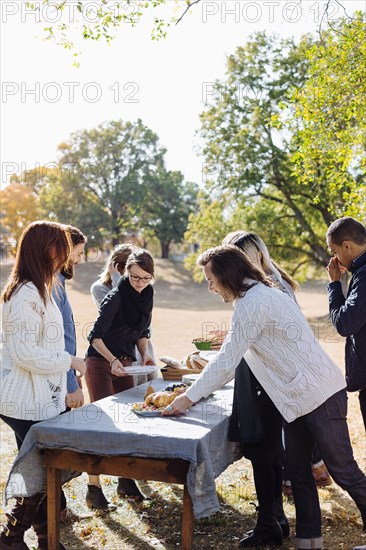 Friends setting outdoor dining table