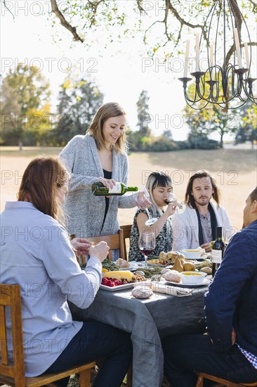 Friends eating at outdoor table