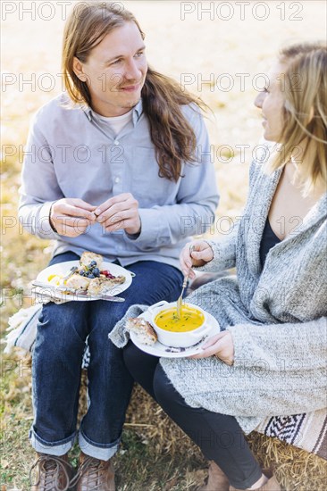 Caucasian couple eating outdoors