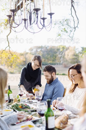 Friends eating at outdoor table