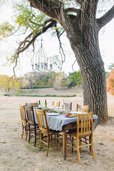 Empty dinner table in field