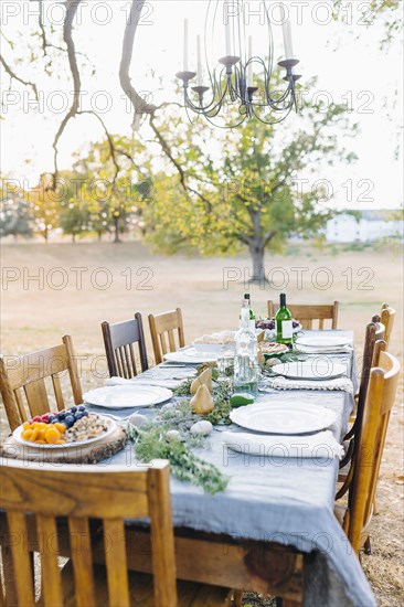 Empty dinner table in field