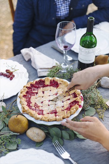 Woman serving pie at outdoor table