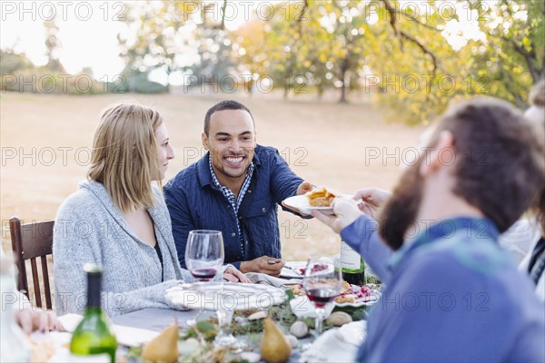 Friends eating pie at outdoor table