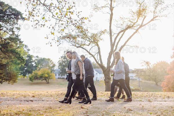 Friends walking in rural field