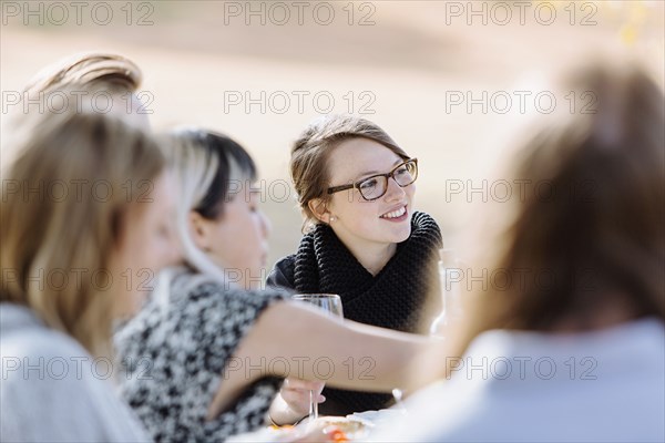 Friends eating at outdoor table