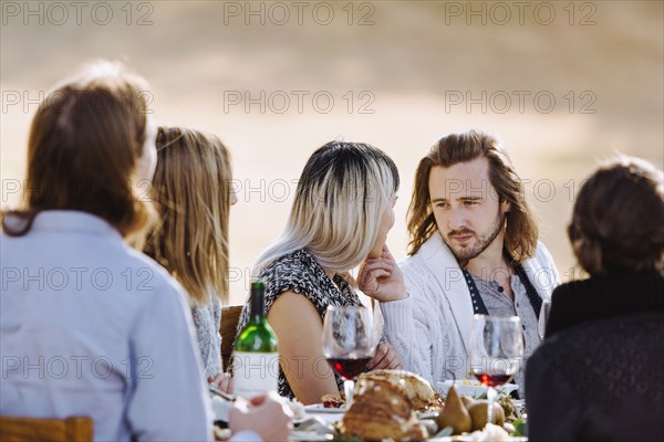 Friends eating at outdoor table