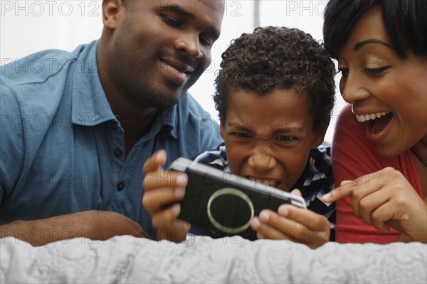 Parents watching son play video game