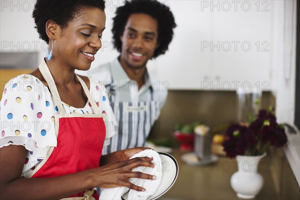 African American woman washing dishes