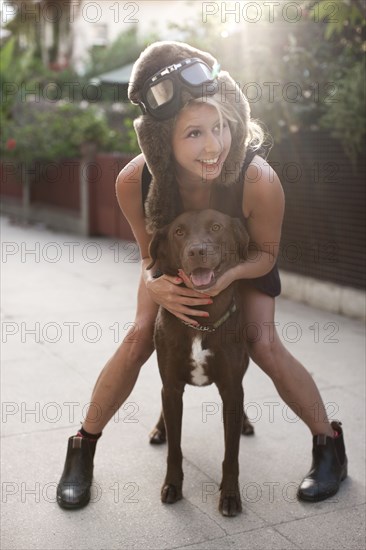 Caucasian woman in fur hat riding dog