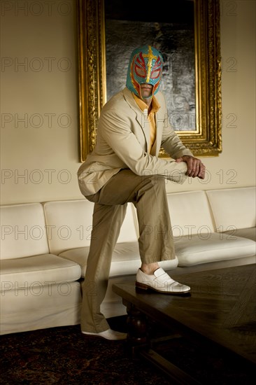 Man wearing wrestling mask in living room