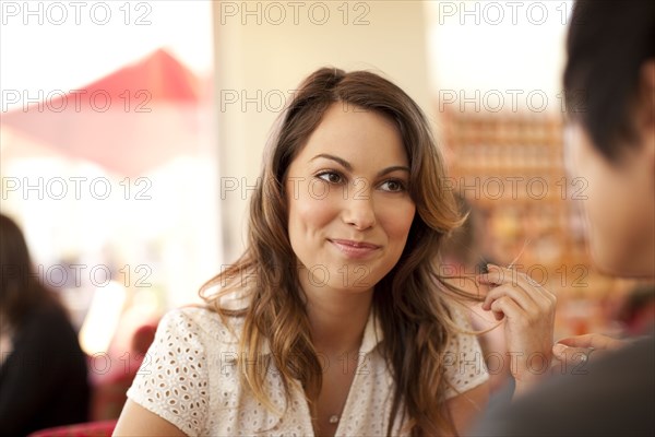 Smiling woman and man sitting face to face