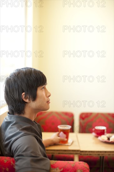 Pensive mixed race man looking up