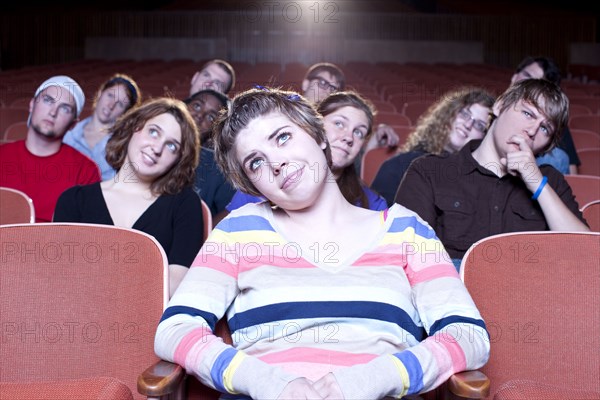 Caucasian woman watching movie in theater