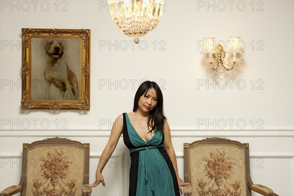 Glamorous Vietnamese woman standing in elegant room