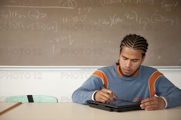 Peruvian student studying in classroom on laptop