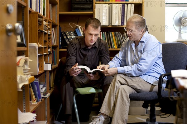 Teacher talking with student about book