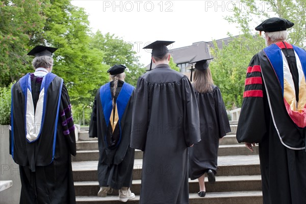 Professors and students walking to graduation