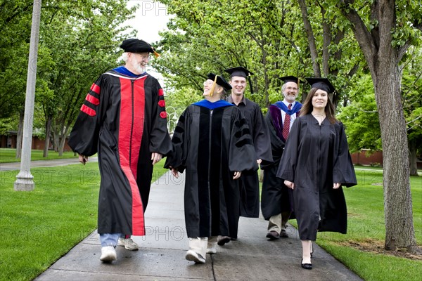 Professors and students walking to graduation