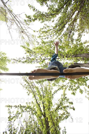 Caucasian man balancing on rope in park