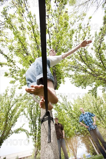 Caucasian man balancing on rope in park