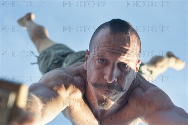 Caucasian man doing handstand