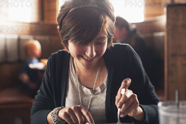 Caucasian teenager eating in restaurant