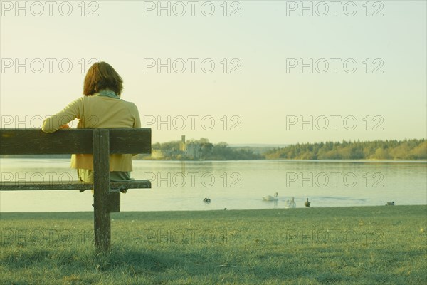 Caucasian teenage girl sitting on park bench