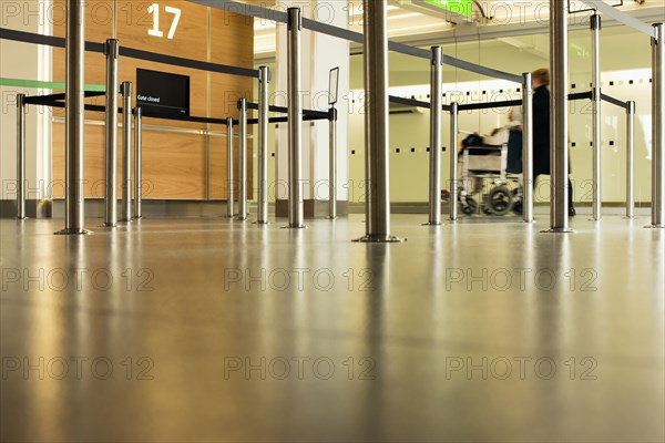 Person pushing wheelchair in airport