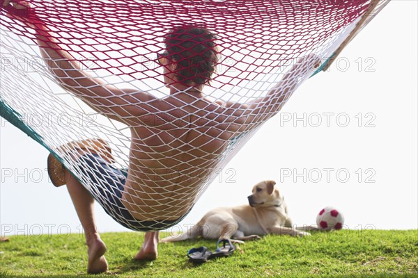 Caucasian man relaxing in hammock