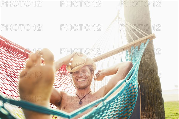 Caucasian man relaxing in hammock