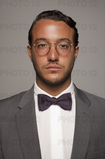 Serious Caucasian man in suit and bow tie