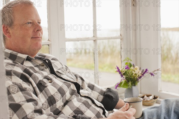 Caucasian man relaxing and drinking coffee