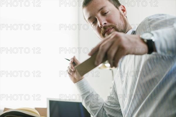 Caucasian businessman looking at prototype