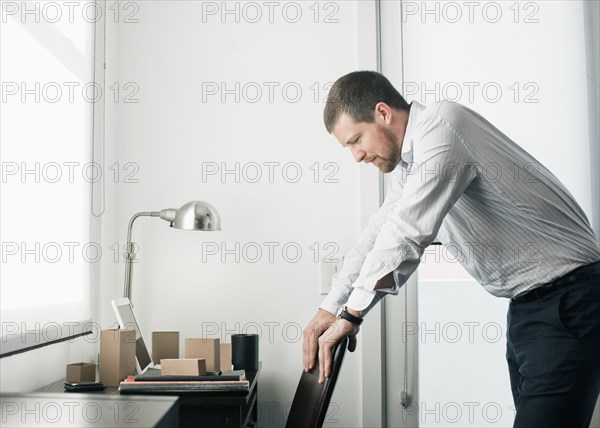 Caucasian businessman leaning on chair